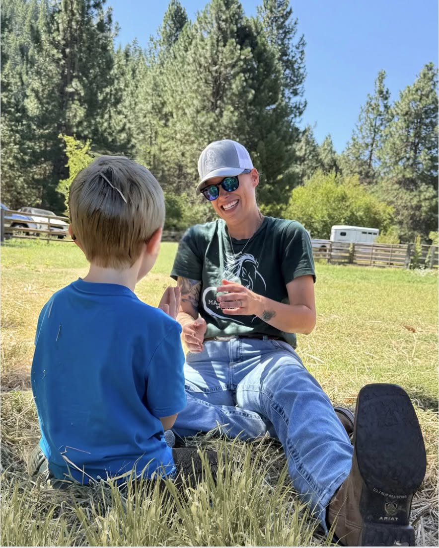 A young participant holding wildflowers at the ranch